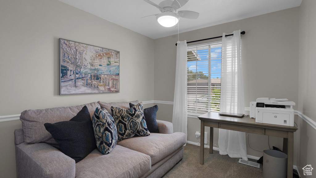 Office space with ceiling fan, carpet, and baseboards