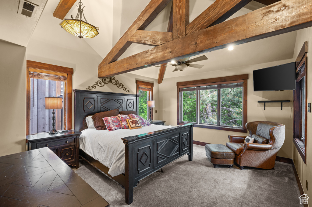 Carpeted bedroom featuring beamed ceiling and high vaulted ceiling