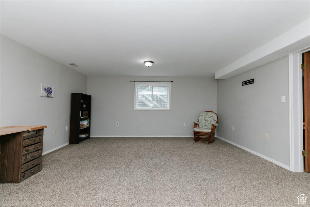 Unfurnished room with light carpet and baseboards
