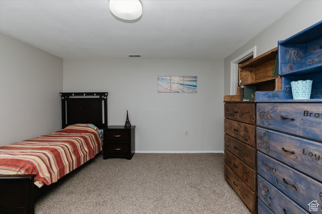 Bedroom with carpet floors and baseboards