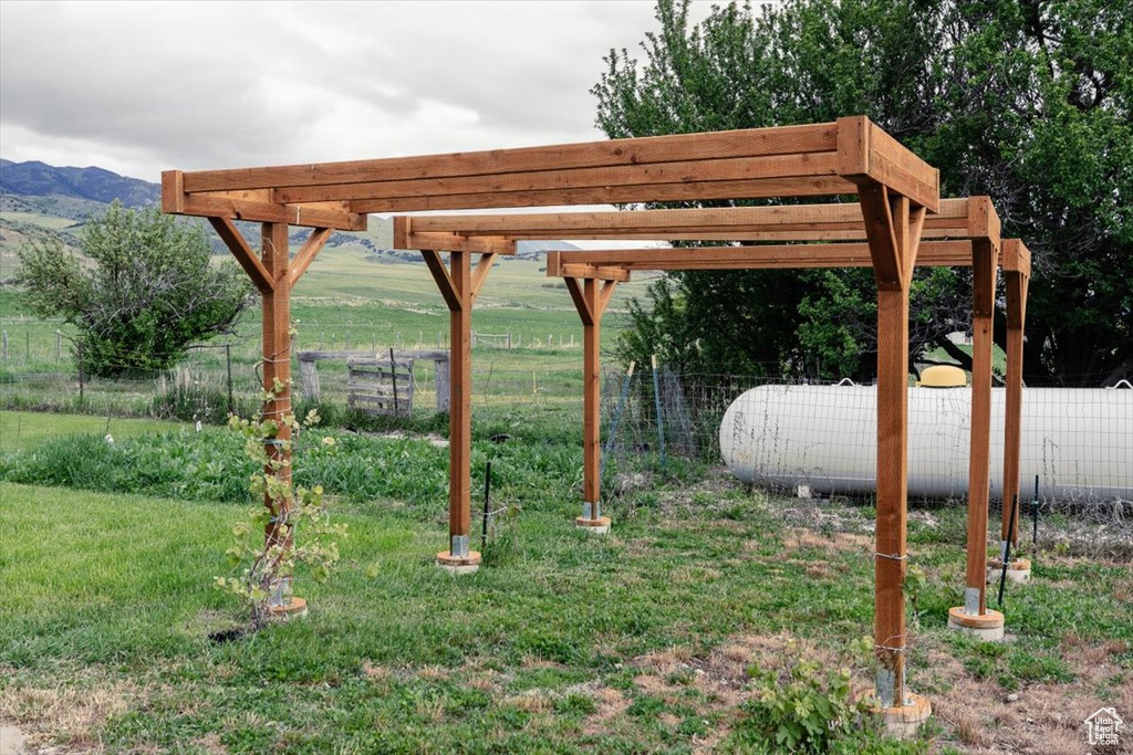 View of yard with a pergola and a mountain view