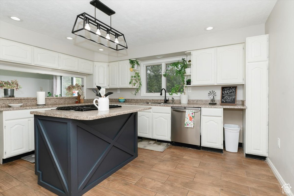 Kitchen featuring stainless steel appliances, a sink, white cabinets, recessed lighting, and healthy amount of natural light