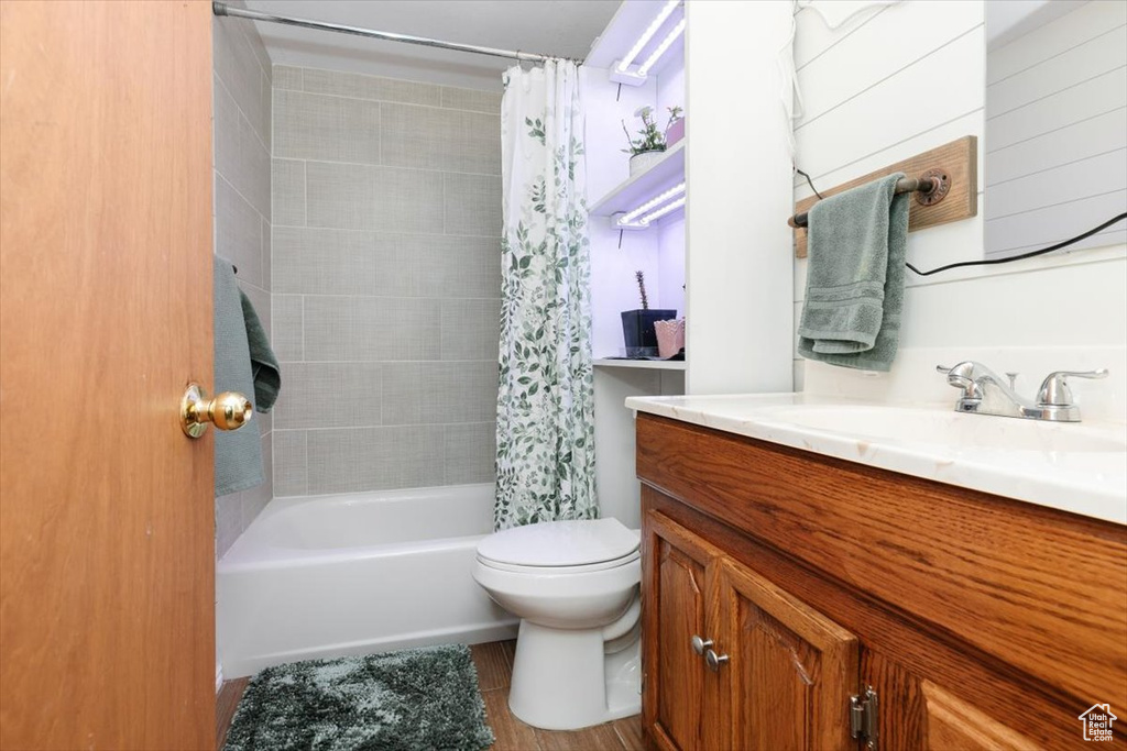 Full bath with toilet, vanity, and shower / bathtub combination with curtain