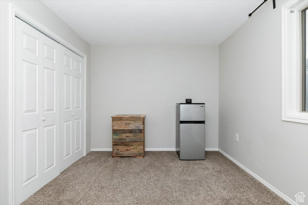 Unfurnished bedroom featuring carpet floors, a closet, and baseboards