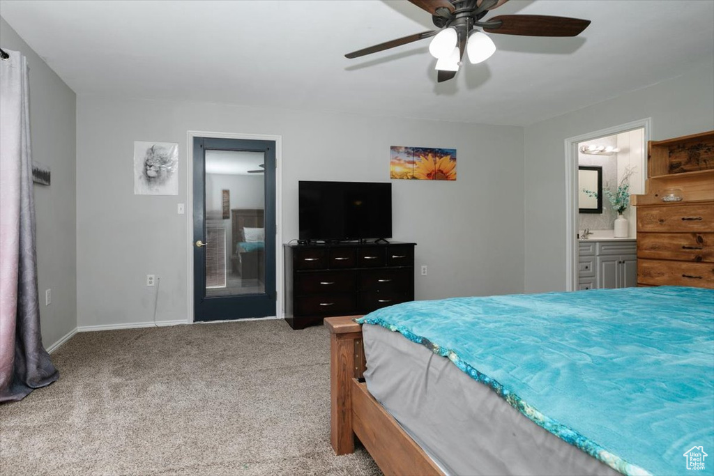 Bedroom with carpet floors, baseboards, ensuite bath, and a ceiling fan