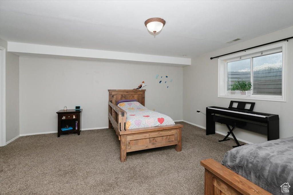 Carpeted bedroom with baseboards