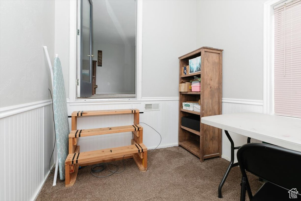 Carpeted office featuring a wainscoted wall
