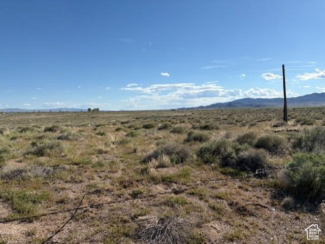 View of mountain backdrop with rural landscape