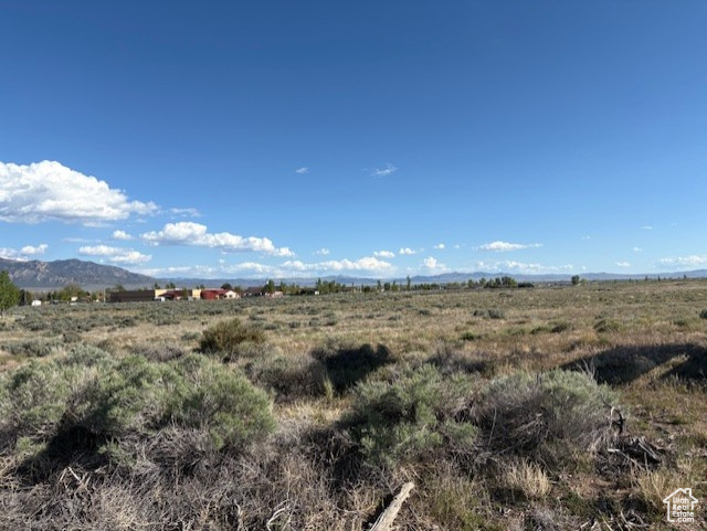View of mountain backdrop featuring rural landscape