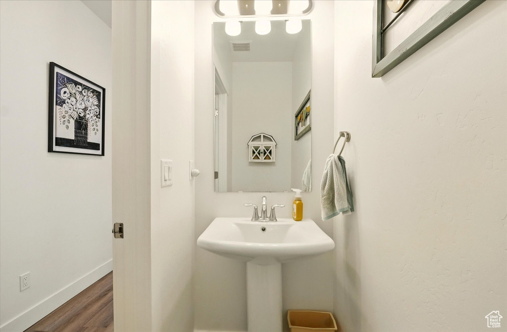 Bathroom featuring wood finished floors and baseboards