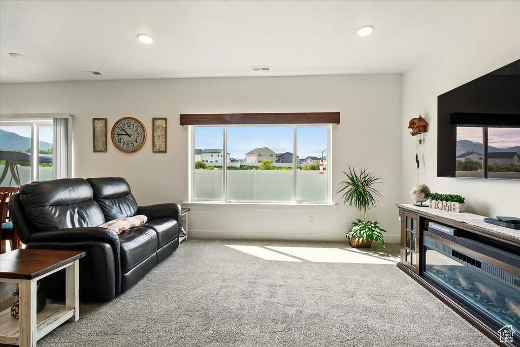 Living area with carpet flooring and recessed lighting