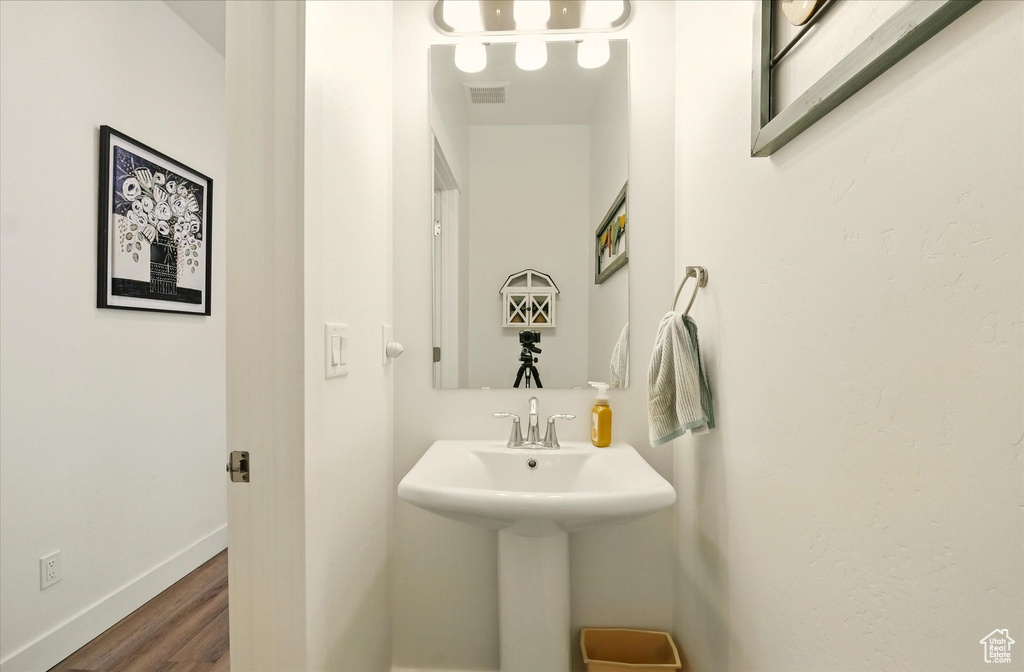 Bathroom featuring wood finished floors and baseboards