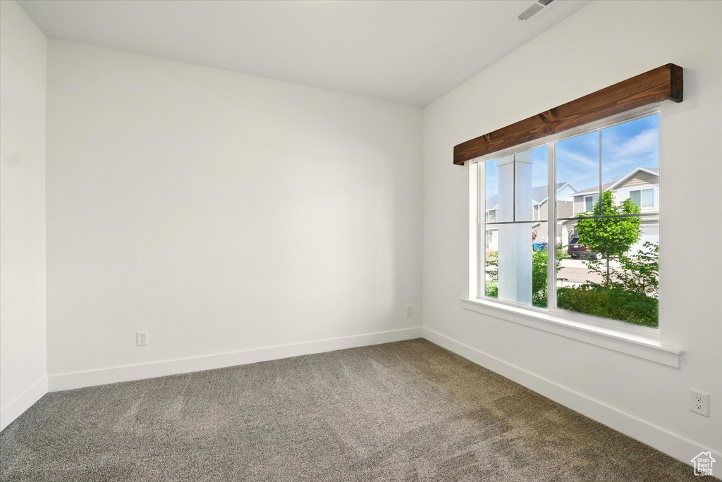 Empty room with carpet flooring and baseboards