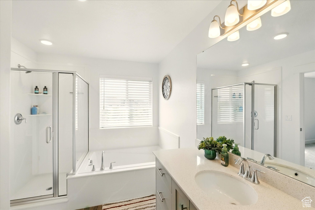 Bathroom featuring a shower stall, vanity, a garden tub, and recessed lighting