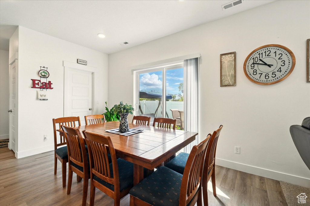 Dining space featuring baseboards, wood finished floors, and recessed lighting