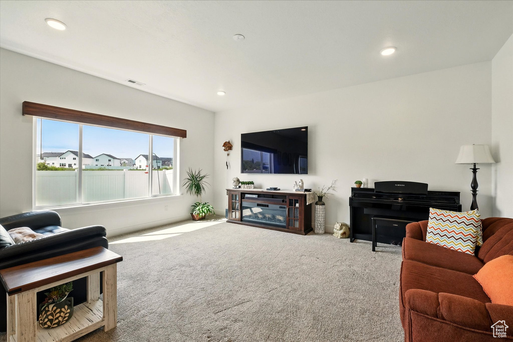 Living area with carpet and recessed lighting