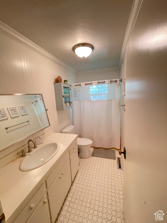 Bathroom with toilet, ornamental molding, vanity, and a shower with curtain