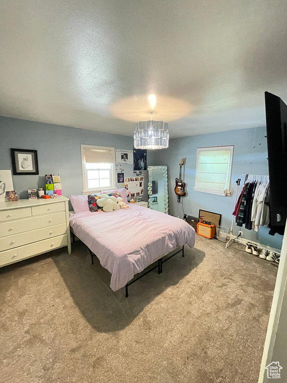 Bedroom with carpet and a textured ceiling