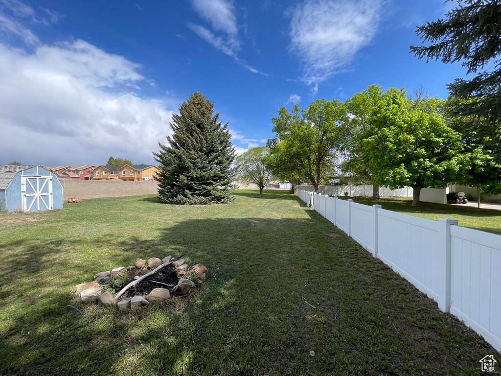 View of yard featuring a storage shed and an outbuilding