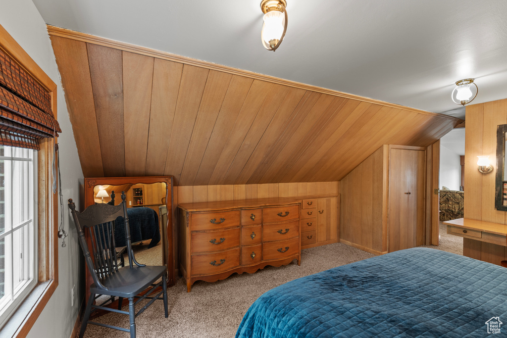 Bedroom with lofted ceiling and carpet flooring