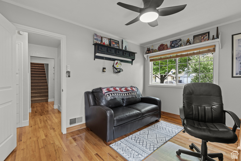 Office with light wood finished floors, ceiling fan, and baseboards