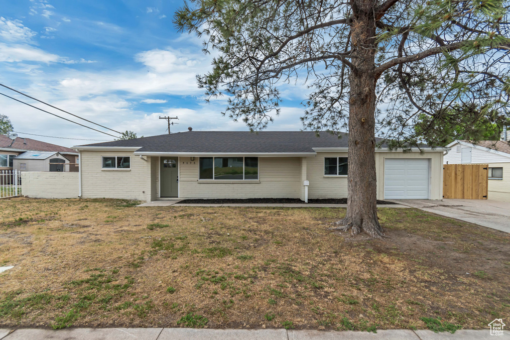 Ranch-style house featuring a garage, concrete driveway, brick siding, and a shingled roof