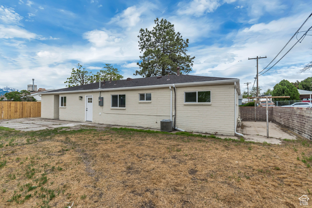 Rear view of house with a patio and central AC unit