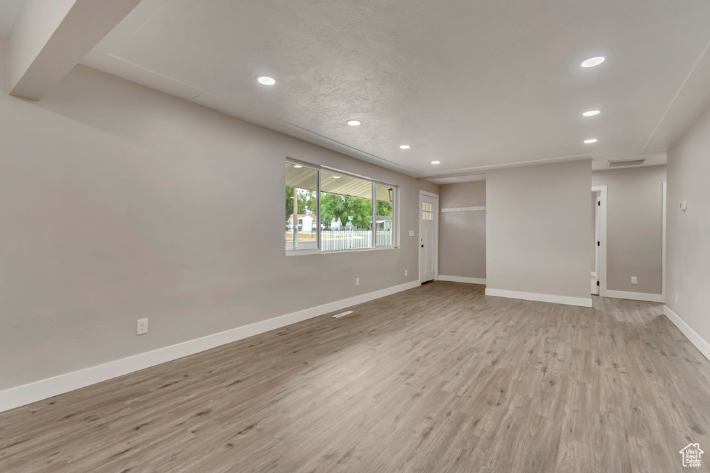 Spare room featuring recessed lighting, baseboards, and light wood finished floors