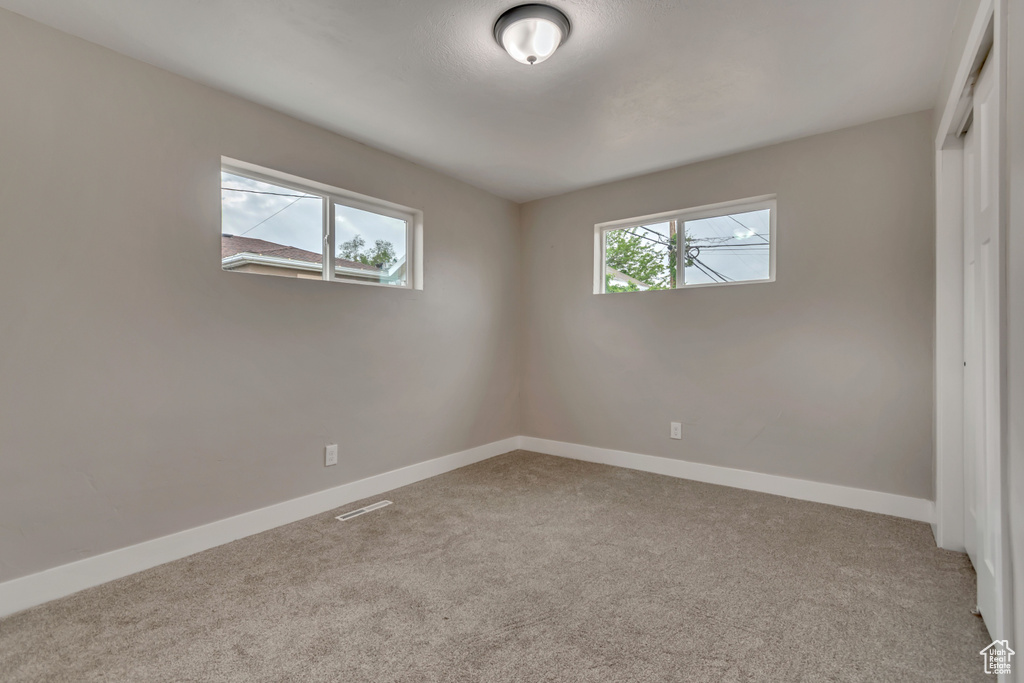 Unfurnished bedroom featuring carpet, baseboards, and a closet