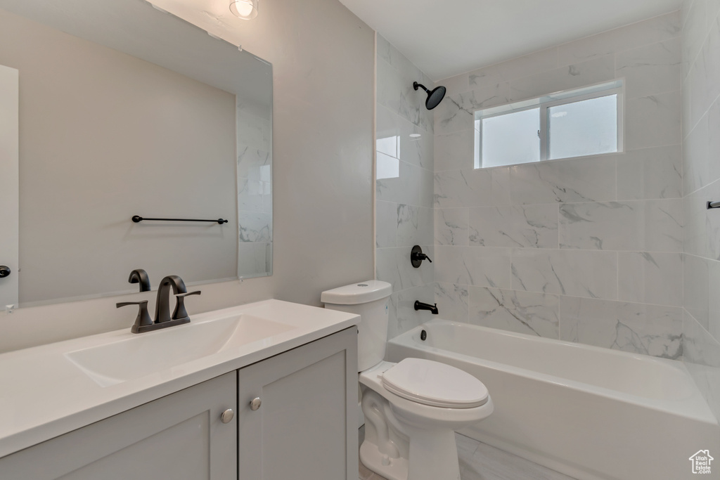 Bathroom with vanity, toilet, and tub / shower combination