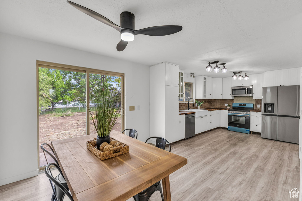 Dining space featuring light wood-style flooring and a ceiling fan