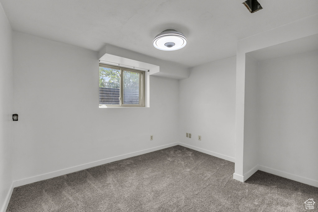 Carpeted empty room featuring baseboards