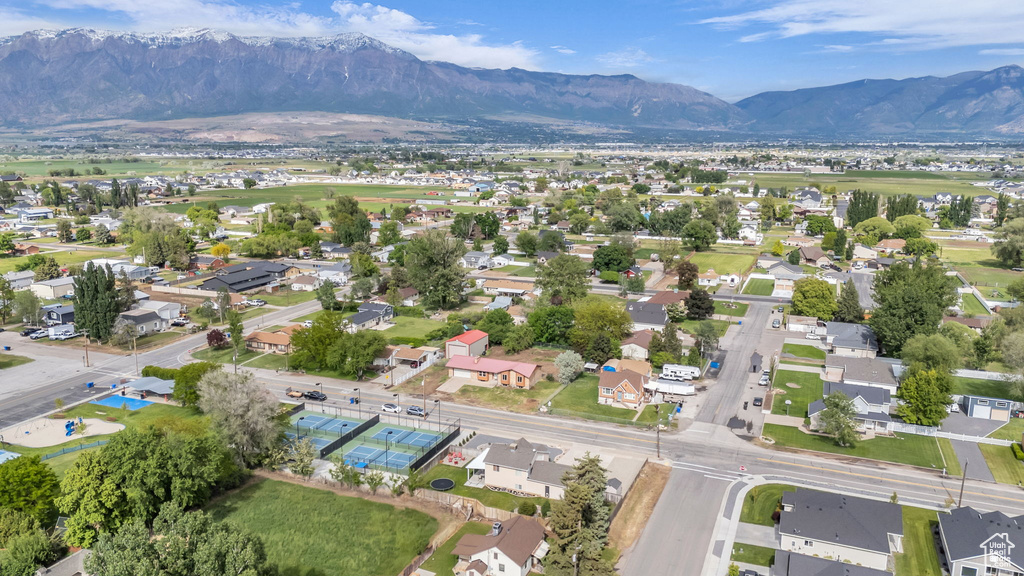 Aerial overview of property\\\\\\\'s location with a mountainous background and nearby suburban area