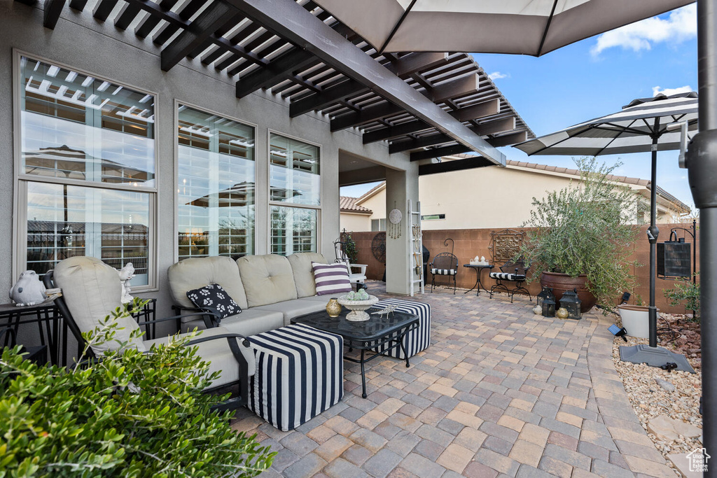 View of patio featuring a pergola and outdoor lounge area