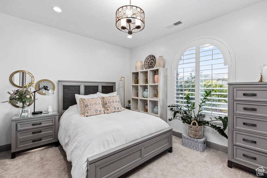 Bedroom featuring light colored carpet, baseboards, recessed lighting, and a chandelier