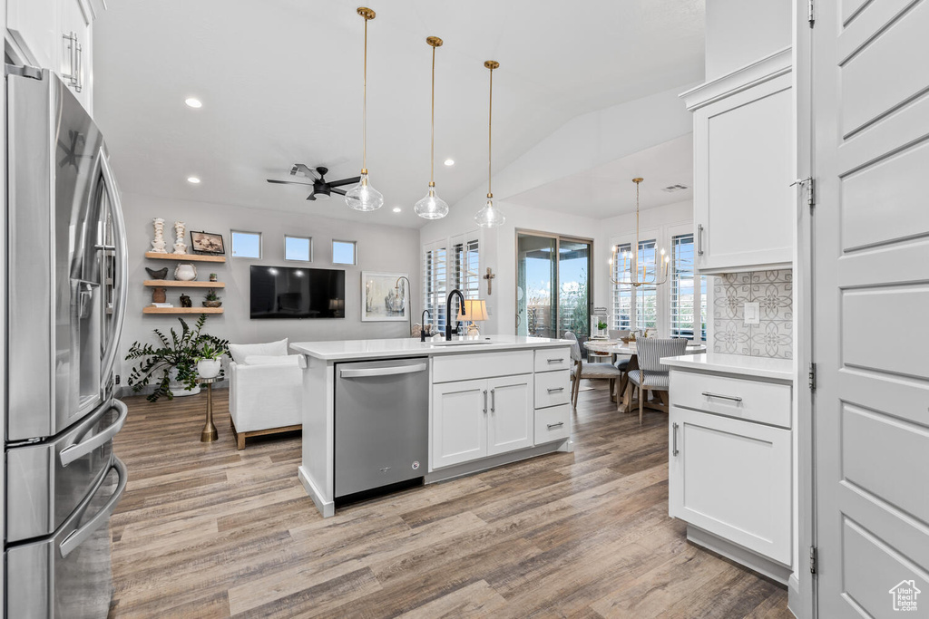 Kitchen featuring stainless steel appliances, a sink, recessed lighting, light wood-type flooring, and a ceiling fan