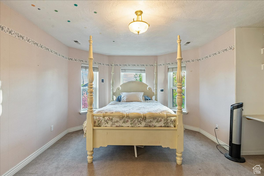 Carpeted bedroom featuring baseboards