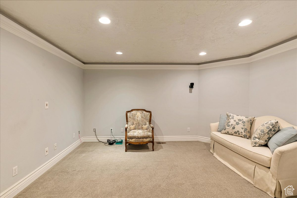 Living area with recessed lighting, ornamental molding, baseboards, and carpet floors