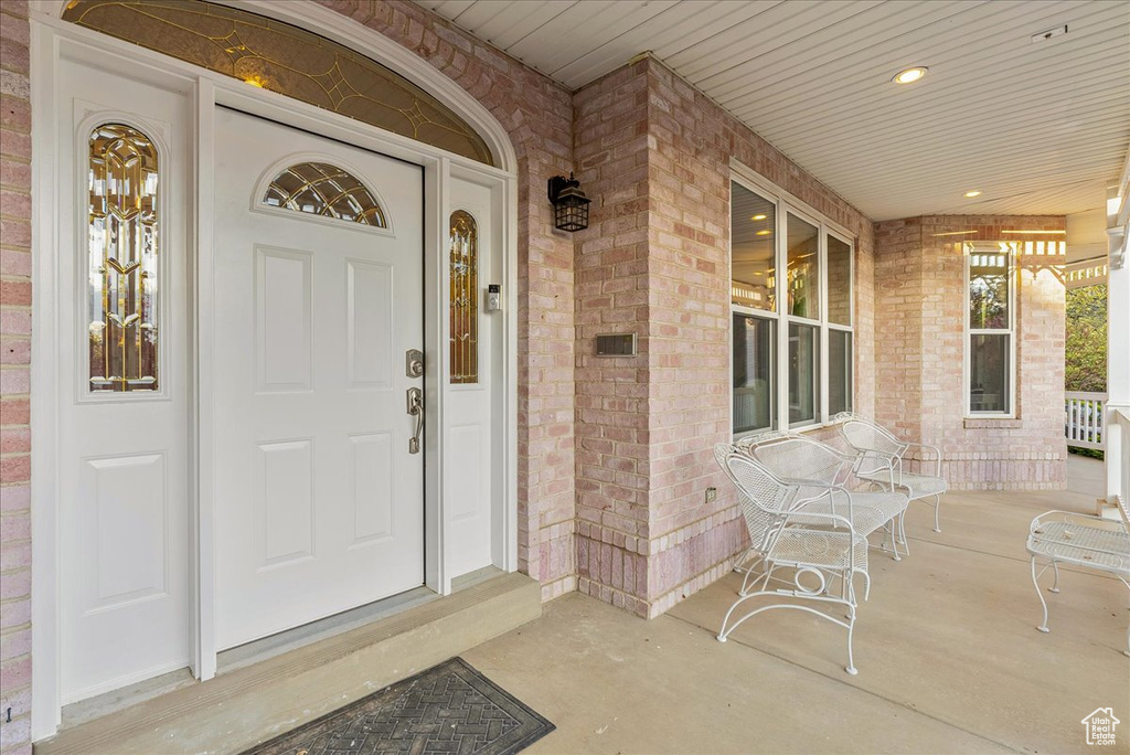 Property entrance with a porch and brick siding