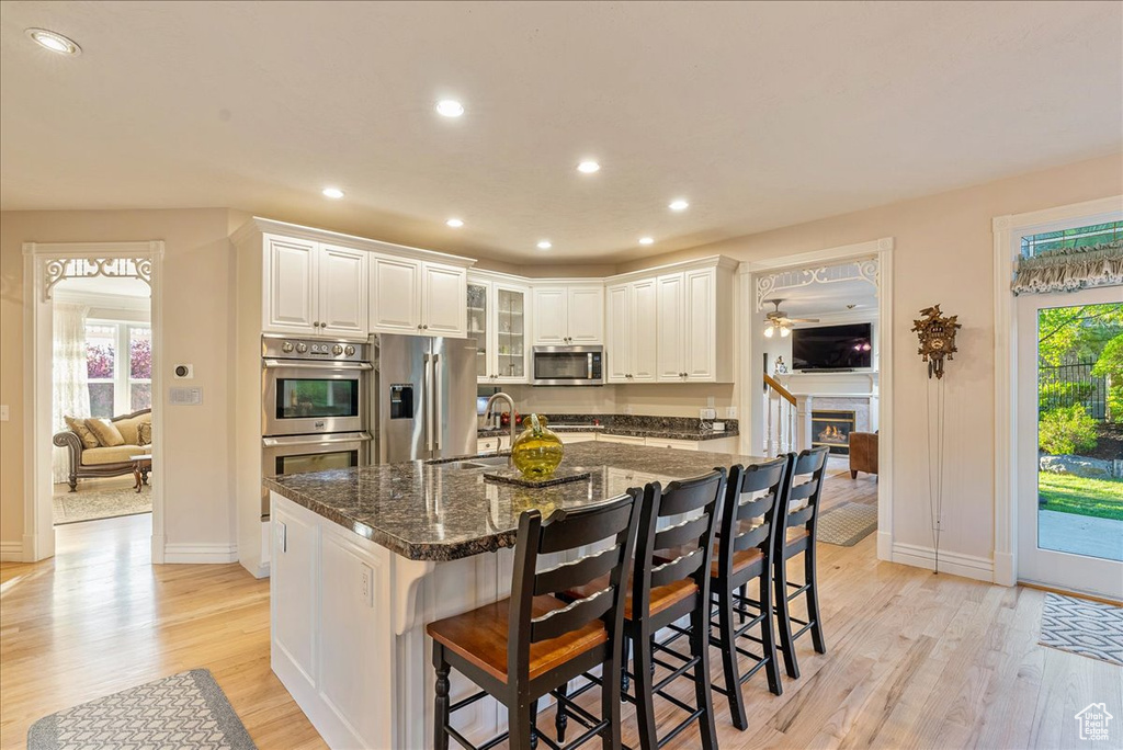 Kitchen with light wood-style floors, stainless steel appliances, recessed lighting, and a sink