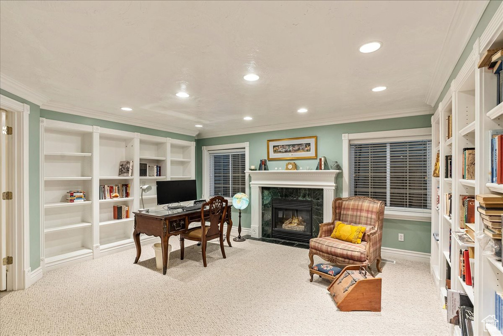 Carpeted office space with crown molding, baseboards, a fireplace, and recessed lighting