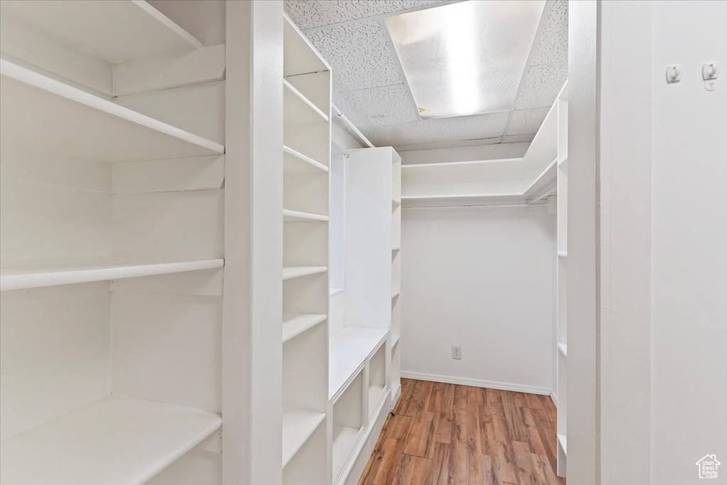 Walk in closet featuring wood finished floors