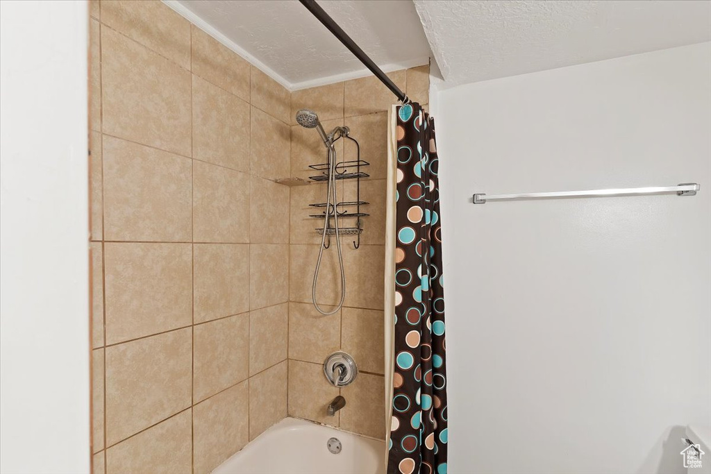 Full bath with shower / bath combination with curtain