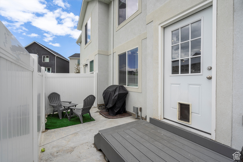 Fenced backyard featuring a patio area and grilling area