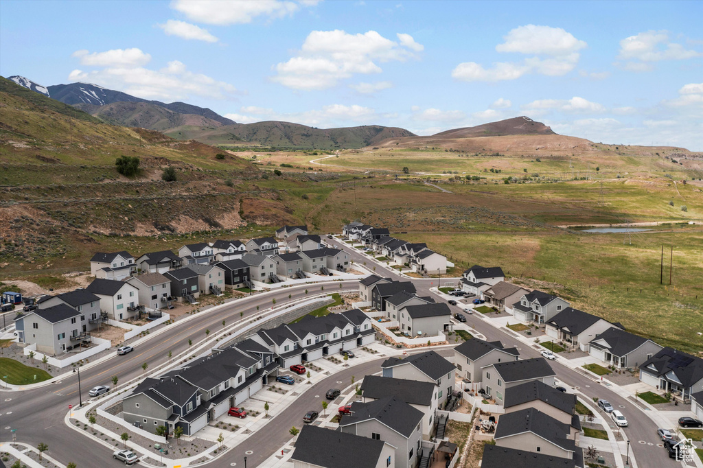Aerial view of property's location featuring nearby suburban area and a water and mountain view