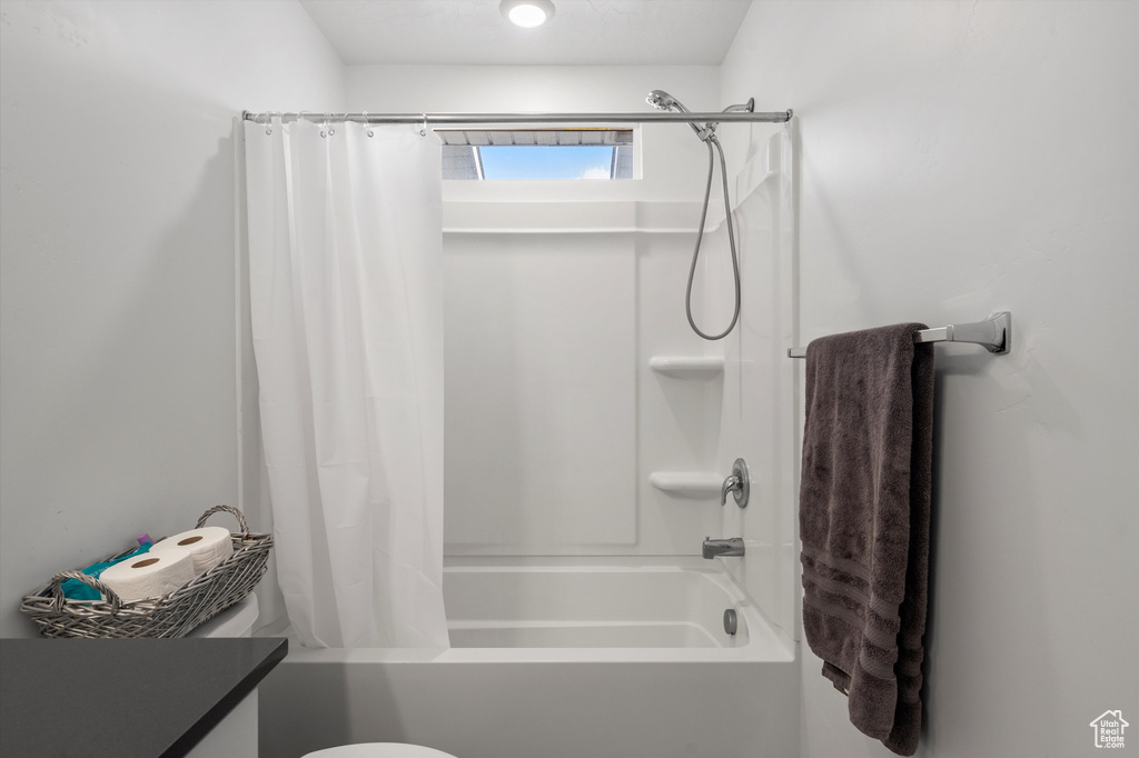Full bath featuring shower / tub combo and vanity