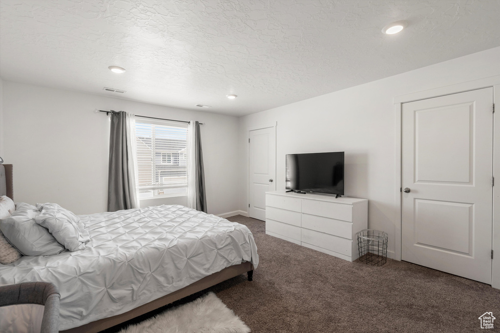 Bedroom featuring carpet flooring, a textured ceiling, and recessed lighting