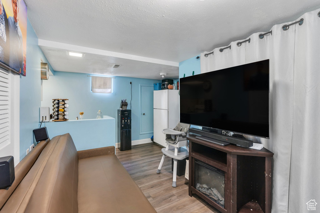 Living area featuring baseboards and wood finished floors