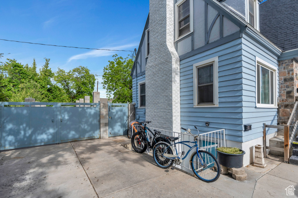 View of property exterior with a gate and fence