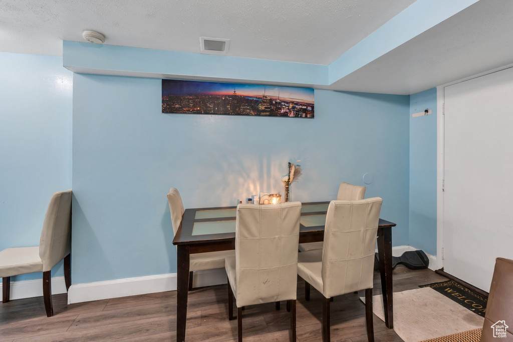 Dining room featuring wood finished floors and baseboards